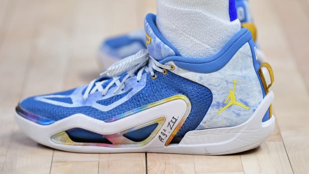 Side view of Jayson Tatum's blue and gold Jordan Brand sneakers.